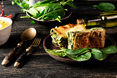 Delicious homemade lasagne with ricotta cheese and spinach on blue stone concreet table background