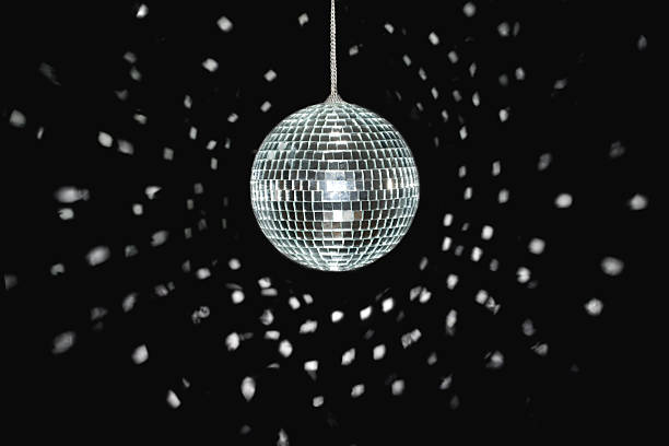 Spinning discoball on black background spinning discoball, over black background, light reflections disco ball stock pictures, royalty-free photos & images