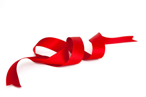 A spiral satin red ribbon with ends cut stock photo