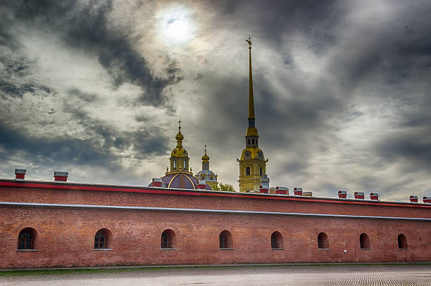 Spire Peter and Paul Cathedral bell tower fortress wall St.-Pet Spire Peter and Paul Cathedral bell tower fortress wall St.-Petersburg cloudy sky Chris Paul stock pictures, royalty-free photos & images