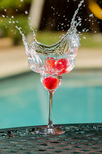 Splash in a cup of water caused for strawberrys stock photo