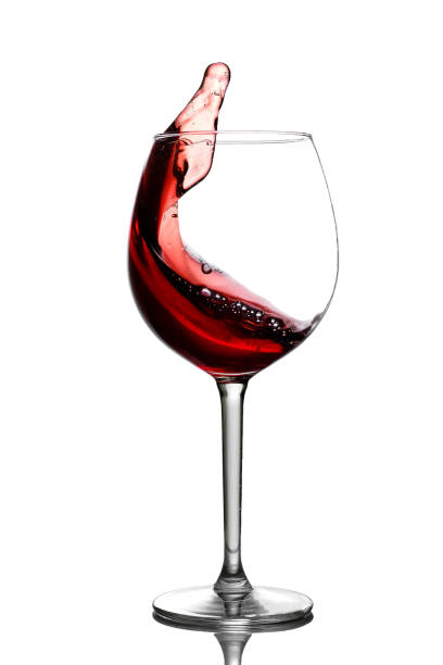 Splash in red wine in a glass stock photo