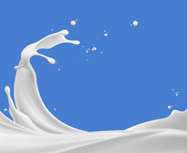 splashing milk milk splash against blue background milk stock pictures, royalty-free photos & images