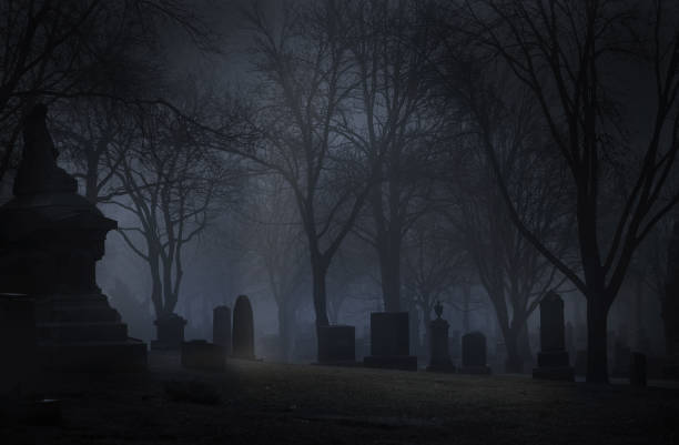 Spooky Cemetery at night with fog Spooky cemetery at night with fog. Desaturated color. cemetery stock pictures, royalty-free photos & images