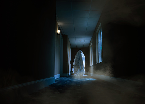 Spooky ghost moving alongside a hotel corridor