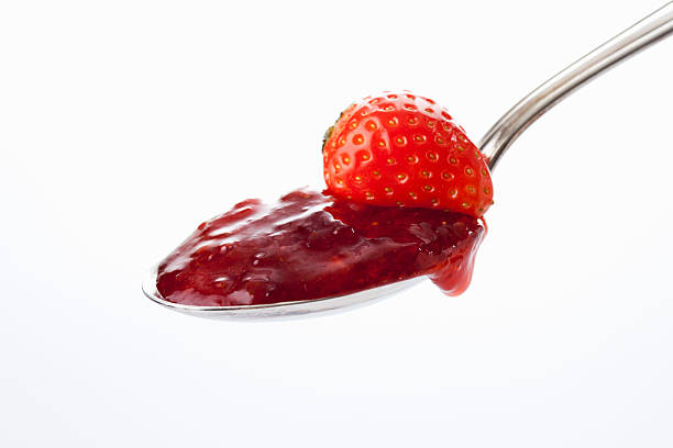 Spoon with strawberry jam and strawberry stock photo