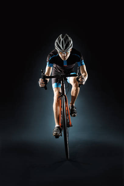 Sport. Athlete cyclists in silhouettes on dark background stock photo