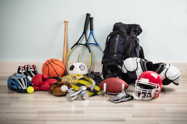 Sport Equipments On Floor Photo Of Various Sport Equipments On Hardwood Floor sporting goods stock pictures, royalty-free photos & images