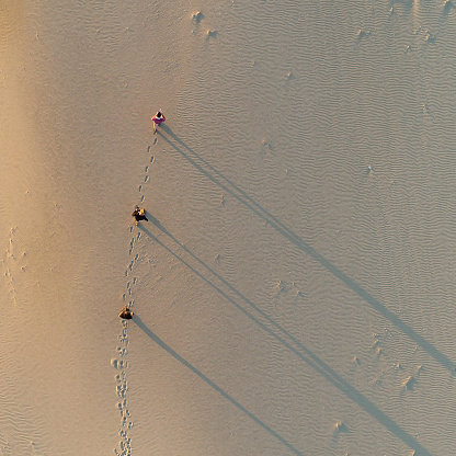 Above shot of a men running on the beach.