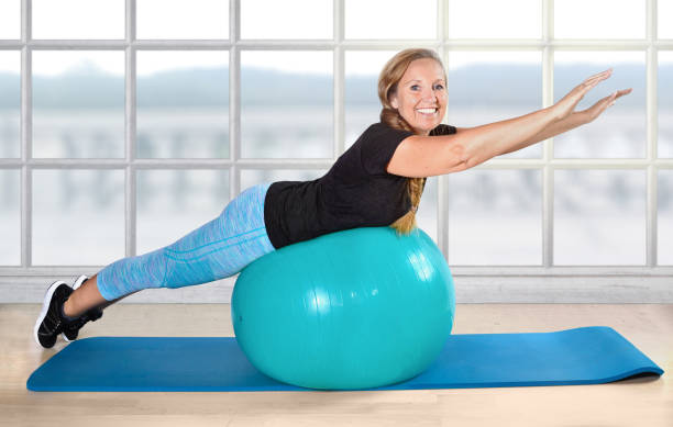 sport retiree pensioner ball exercise age fit senior woman in fitness studio on a ball pelvic floor stock pictures, royalty-free photos & images