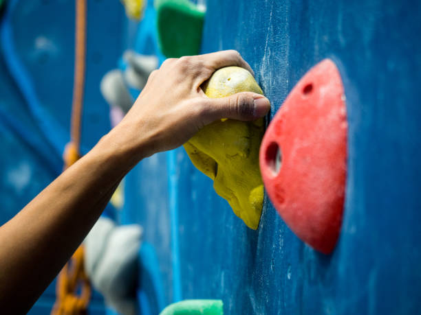 sport woman hanging extreme sport climbing wall in indoor gym sport woman hanging extreme sport climbing wall in indoor gym bouldering stock pictures, royalty-free photos & images
