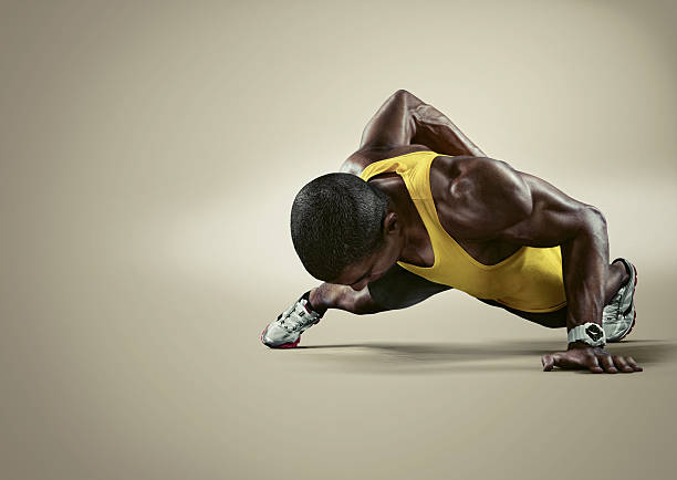 Sport. Young athletic man doing push-ups. stock photo