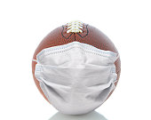 istock Sports and Covid-19 Concept.  End shot of an american Foortball with a surgical mask. 1281073420