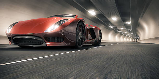 Sports Car in a Tunnel A red sports car speeding through a tunnel. This car is designed and modelled by myself. Very high resolution 3D render. All markings are ficticious. concept car stock pictures, royalty-free photos & images