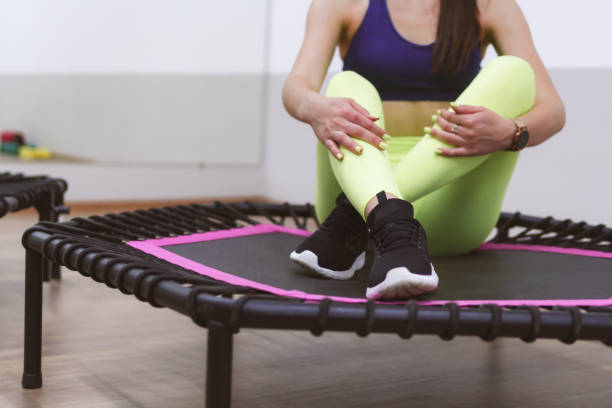 sports girl and sports trampoline for jumping stock photo