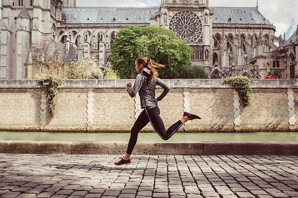 sports woman jogging in paris - train travel stockfoto's en -beelden