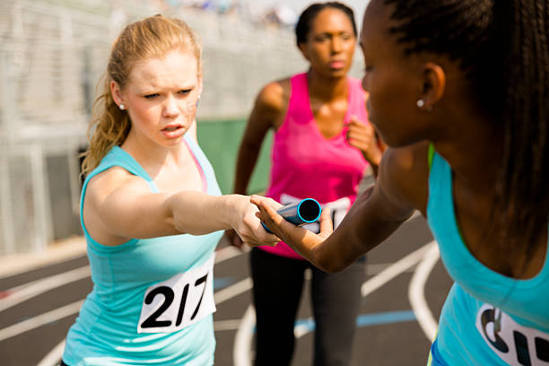 sports:  women's relay race, track competition. - teen girls team sport bildbanksfoton och bilder