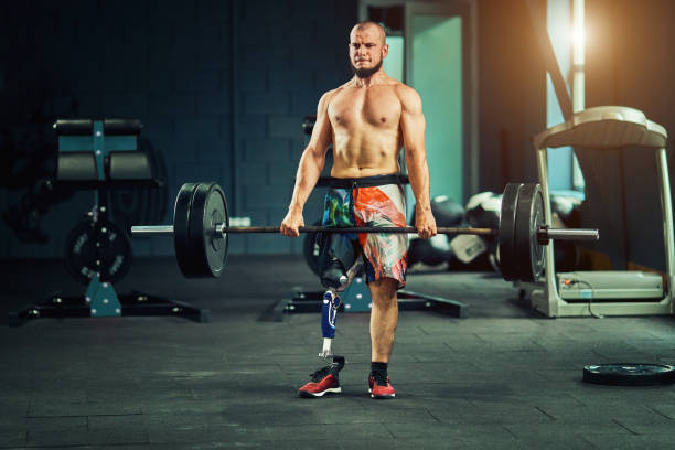 Sportsman with prosthesis working out in gym stock photo