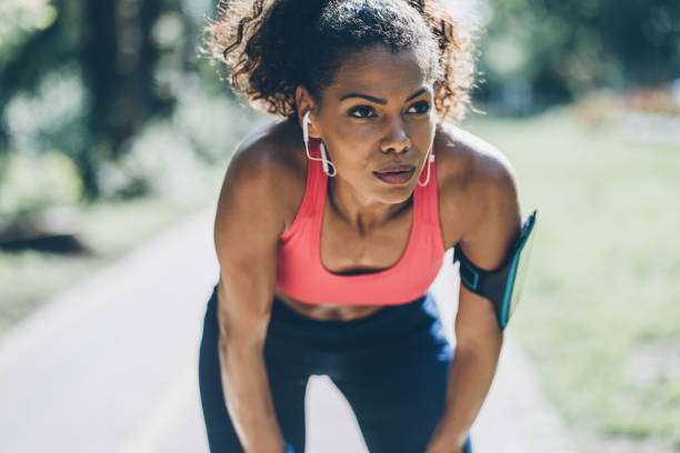 Sportswoman resting Young african-american woman resting after work out outdoors effort stock pictures, royalty-free photos & images