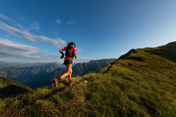 Sporty mountain woman rides in trail during endurance trail stock photo