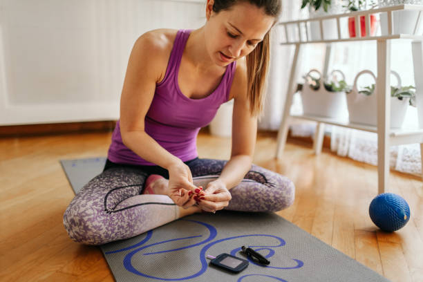 Sporty Woman Is Measuring Blood Sugar Level stock photo