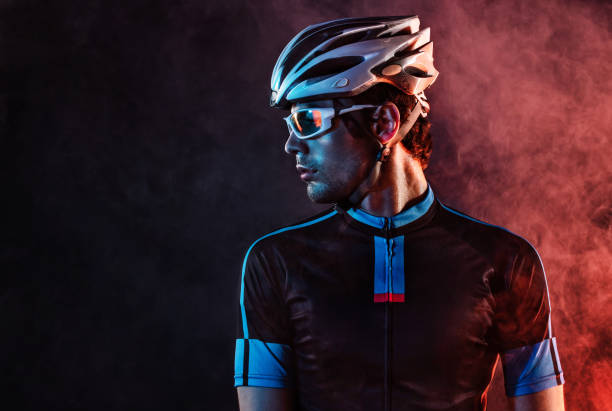 Spost background with copyspace. Cyclist. Dramatic colorful close-up portrait. stock photo