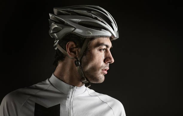 Spost background with copyspace. Cyclist. Dramatic colorful close-up portrait. stock photo