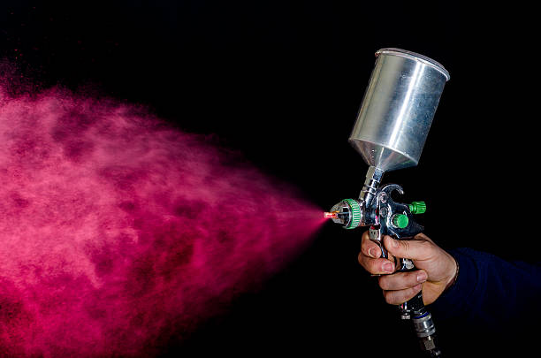 Spray gun Photo of spray gun isolated on black background airbrush stock pictures, royalty-free photos & images