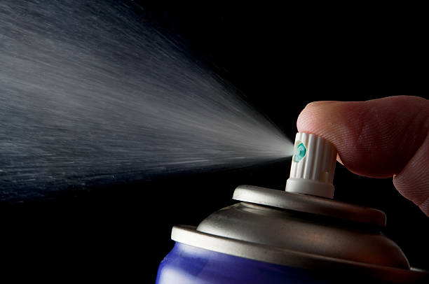 Spraying aerosol can isolated in black stock photo