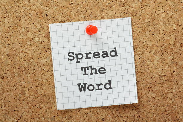 Spread The Word Spread the Word typed on a piece of graph paper and pinned to a cork notice board spreading stock pictures, royalty-free photos & images