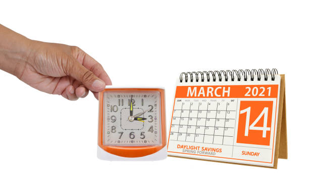 Spring Forward Spring forward Day light savings time calendar and hand holding clock daylight savings 2021 stock pictures, royalty-free photos & images