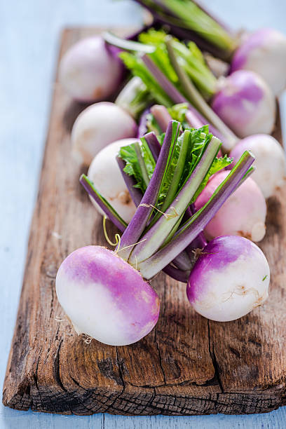 Spring fresh young purple turnip Spring fresh young purple turnip, on wooden rustic chopping board turnip stock pictures, royalty-free photos & images