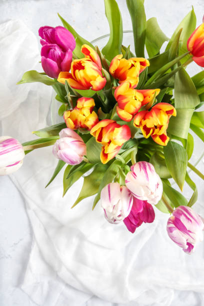 Spring Tulip bouquet in pink and yellow from above on Easter table  easter sunday stock pictures, royalty-free photos & images