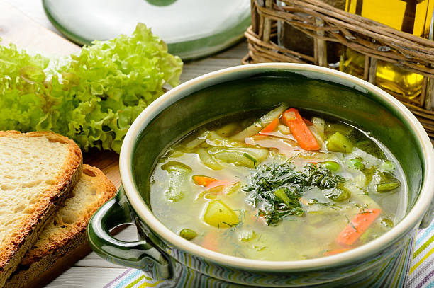 Spring vegetable soup in green bowl. stock photo