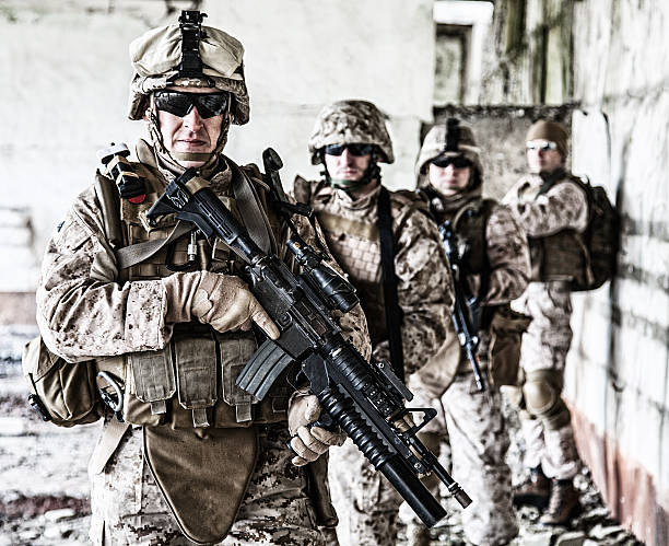Squad of marines Squad of US marines in ruined building us military stock pictures, royalty-free photos & images