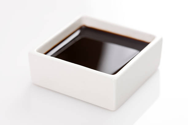 A square container of soy sauce stock photo