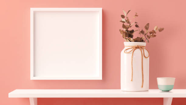 Square photo frame mockup hanged in the home wall with a shelf in 3D rendering. Modern home interior design, blank empty frame template, nordic style stock photo