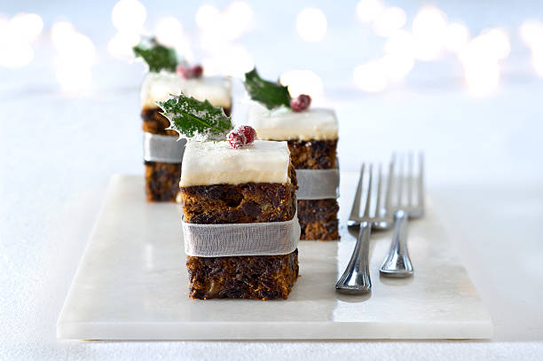 Squares of Christmas cake adorned with a cranberry stock photo