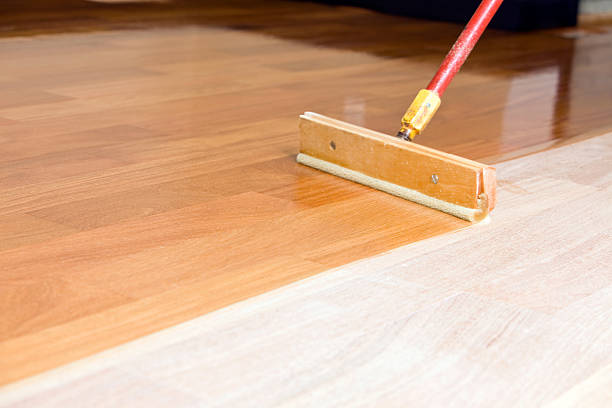 Squeegee Style Brush Applying Clear Polyurethane to Hardwood Floor  flooring refinishing stock pictures, royalty-free photos & images