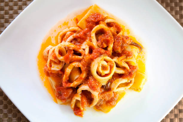 squid, squid pasta and tomato sauce stock photo