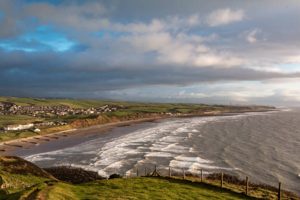 St. Bees beach, Cumbria The coastline at St Bees beach in Cumbria, UK. The waves roll in from the Irish sea and crash against the rocks. The small village of St Bees and the surrounding area can be seen.

Shot just before Christmas, 2018 cumbria stock pictures, royalty-free photos & images