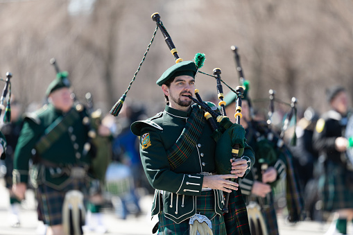 Chicago, Illinois, USA - March 16, 2019: St. Patrick's Day Parade, Members of the Shannon Rovers Pipe Band performing at the parade