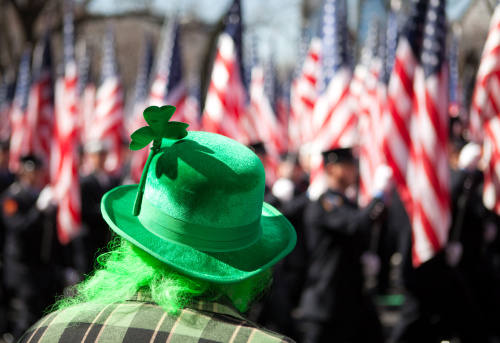 St. Patrick's Day parade in Manhattan, New York City. Extremely shallow depth of field, focus on the three leafed clover. Defocused American flags in the background. Location: New York City along 5th Avenue. Year: 2009