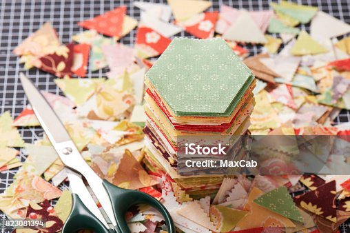istock Stack english paper pieced hexagons surrounded by scraps 823081394