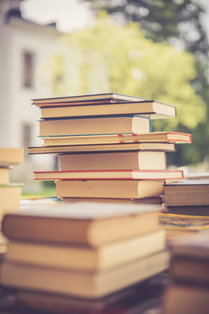 Stack of books at a charity book flea market, text space stock photo