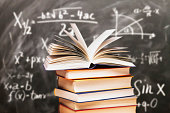 istock Stack of books in front of a blackboard 1198644091