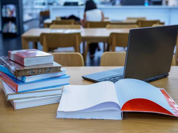 Stack of books on table top in the library / Education & Back to school concept stock photo