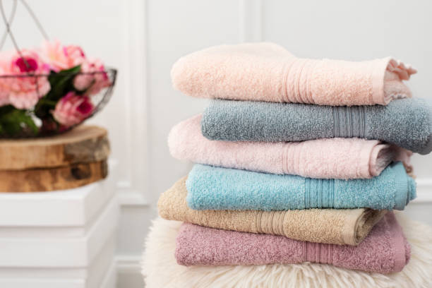 Stack of clean soft colorful towels. Flowers on background  fluffy stock pictures, royalty-free photos & images