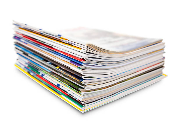 stack of color magazine pile of color magazines - selective focus on foreground magazine publication stock pictures, royalty-free photos & images