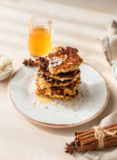 Stack of delicious apple pancakes or fritters with honey, spices and almond. Sunny morning. Autumn breakfast. stock photo